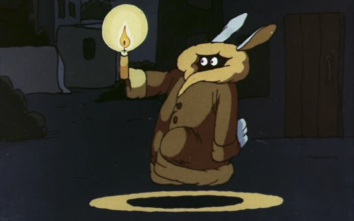 Кролик в пуховике держит свечку